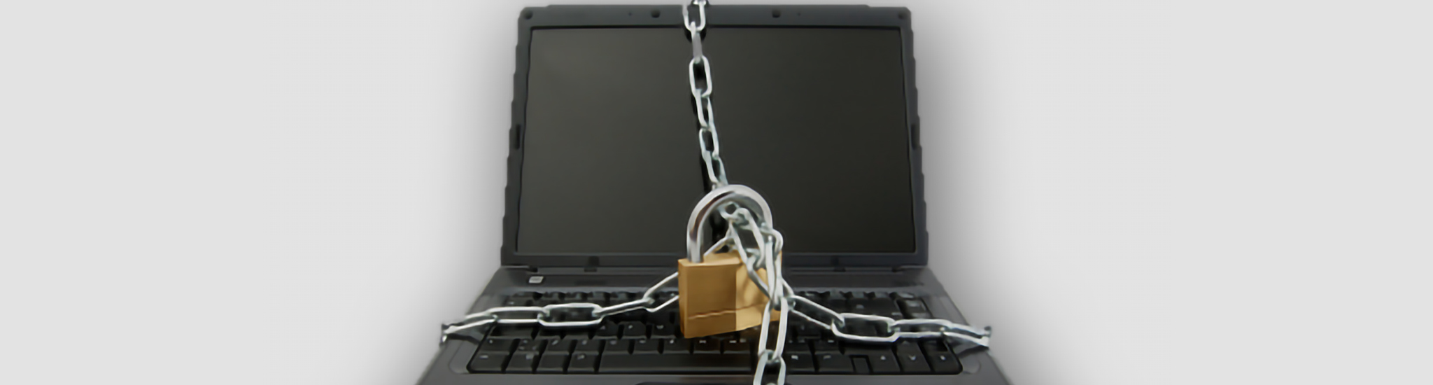 A laptop with a lock and chain around it