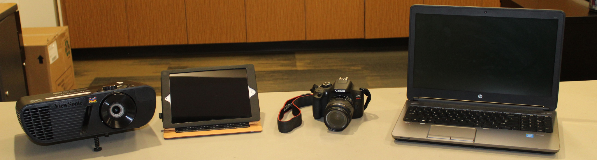 A laptop, camera, iPad, and projector available for rent from IT Equipment Rental